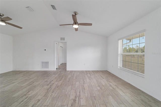 empty room featuring ceiling fan, lofted ceiling, and light hardwood / wood-style floors