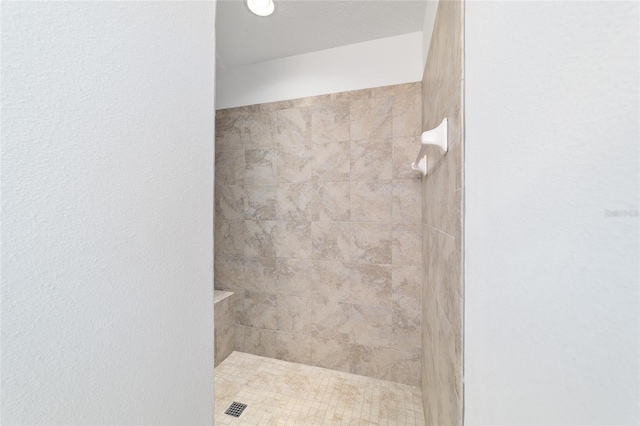 bathroom with tiled shower