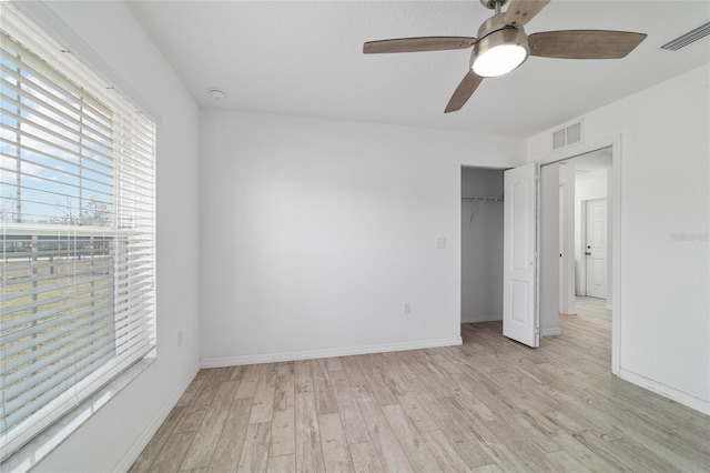 unfurnished bedroom featuring light hardwood / wood-style floors, a closet, and ceiling fan