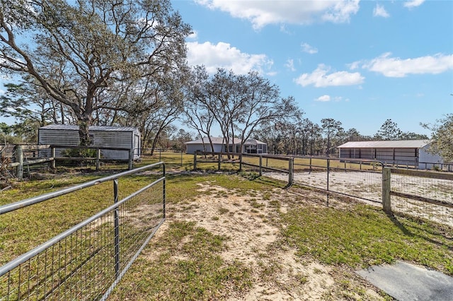 view of yard with a rural view and an outdoor structure