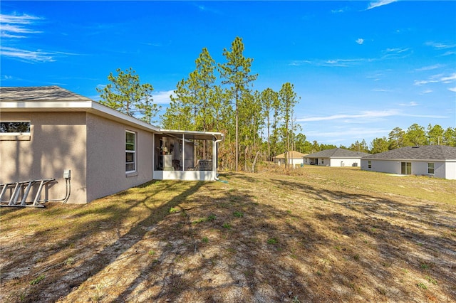 view of yard with a sunroom