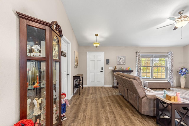 living room featuring dark hardwood / wood-style floors and ceiling fan