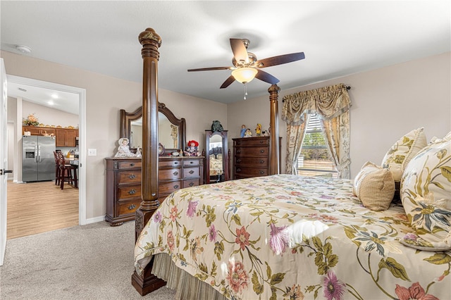 carpeted bedroom featuring ceiling fan and stainless steel fridge