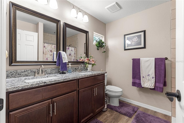 bathroom featuring hardwood / wood-style flooring, vanity, toilet, and a shower with shower curtain