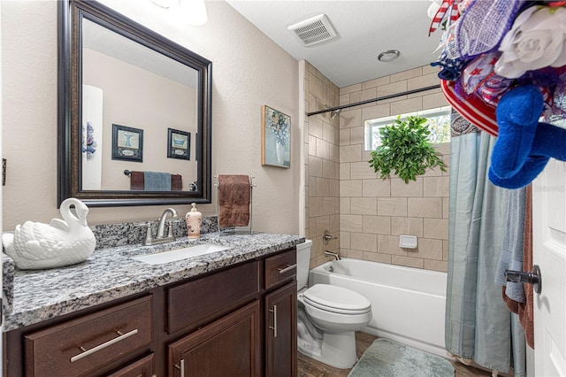 full bathroom with shower / bath combination with curtain, vanity, and toilet