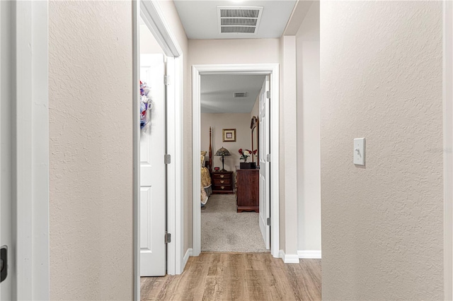 corridor featuring light hardwood / wood-style flooring