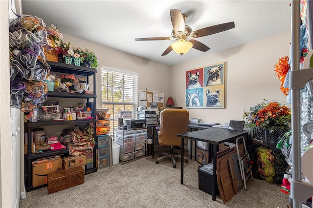 office area featuring light carpet and ceiling fan