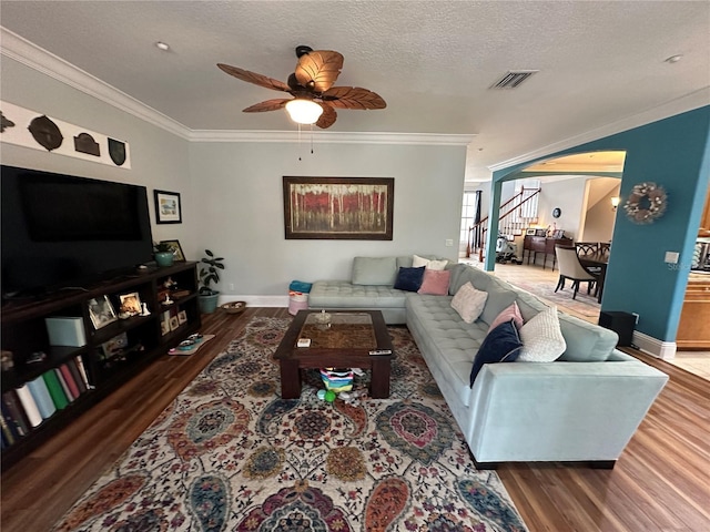 130 Harbour Cove Way, Clermont, FL 34711 - living area featuring wood finished floors, crown molding, baseboards, ceiling fan, and stairs