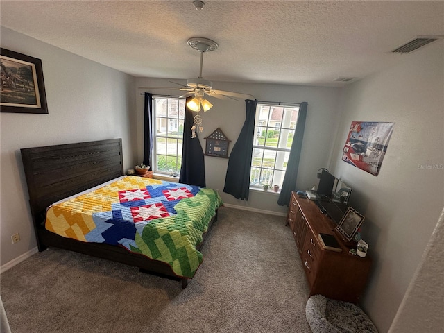 130 Harbour Cove Way, Clermont, FL 34711 - bedroom featuring a textured ceiling, carpet flooring, baseboards, and a ceiling fan