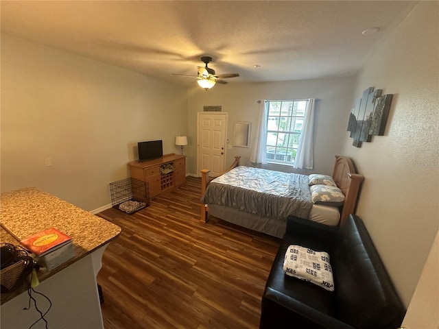 130 Harbour Cove Way, Clermont, FL 34711 - bedroom with dark wood-style floors, a ceiling fan, and baseboards