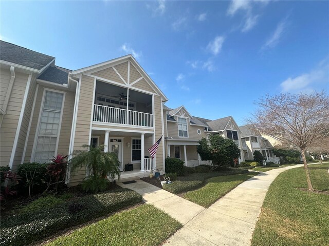 130 Harbour Cove Way, Clermont, FL 34711 - view of property with a porch, a balcony, a front lawn, and a residential view
