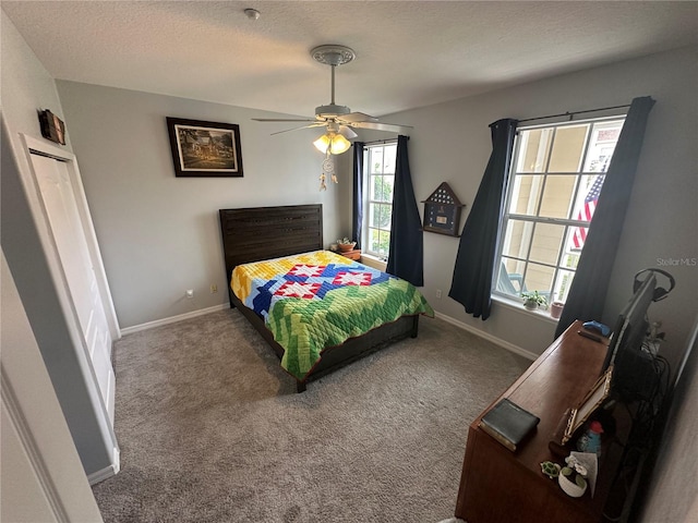 130 Harbour Cove Way, Clermont, FL 34711 - bedroom featuring carpet flooring, baseboards, a textured ceiling, and a ceiling fan
