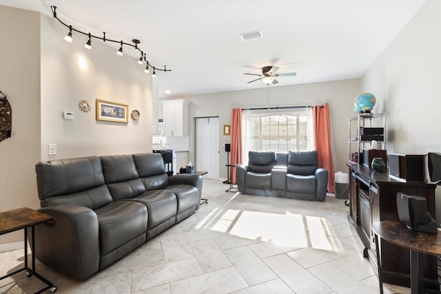 living room featuring track lighting and ceiling fan