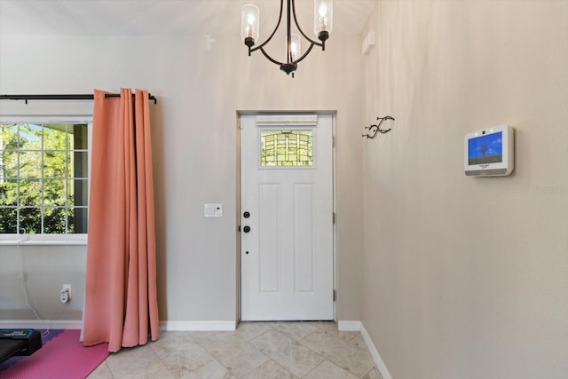 foyer entrance featuring a chandelier