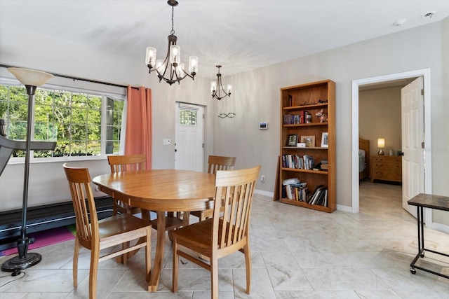 dining area featuring an inviting chandelier