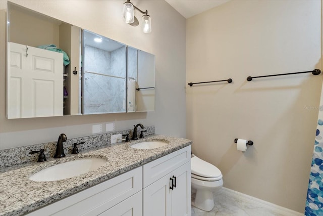 bathroom with vanity, curtained shower, and toilet