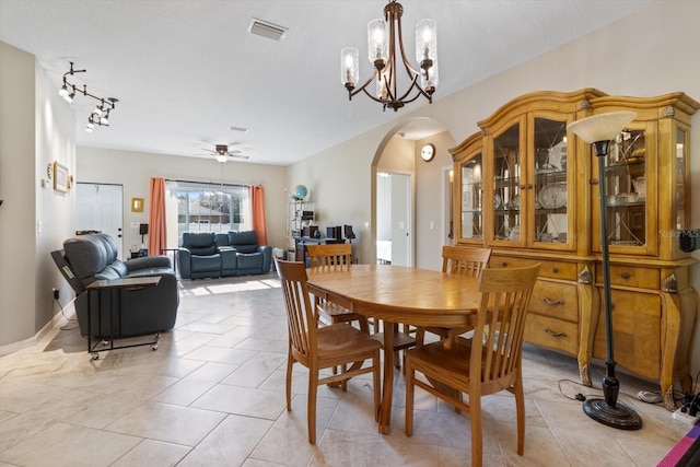 dining area featuring ceiling fan with notable chandelier