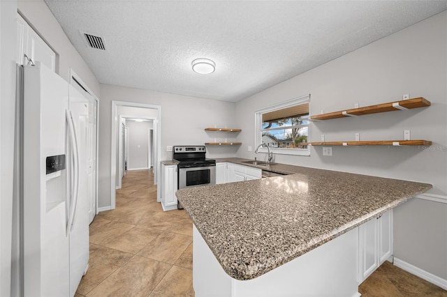 kitchen featuring white cabinetry, white fridge with ice dispenser, electric range, and kitchen peninsula