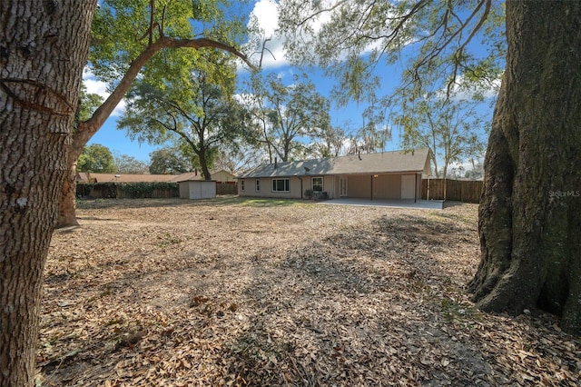 exterior space featuring a storage shed and a patio