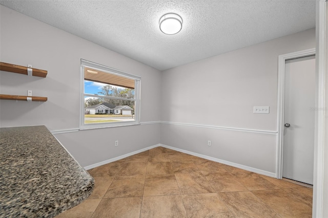 empty room featuring a textured ceiling