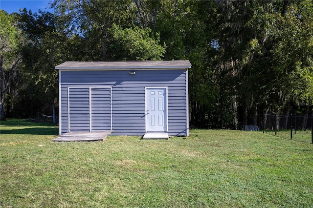 view of outbuilding with a yard