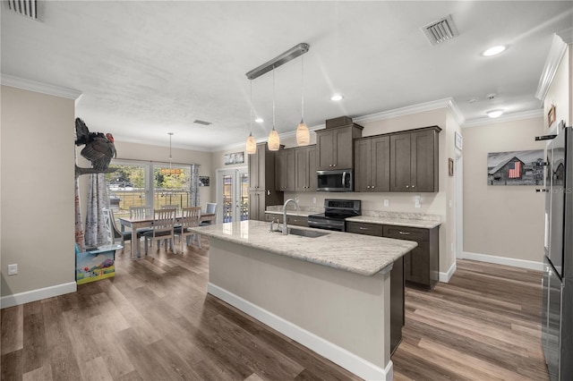 kitchen with pendant lighting, sink, a kitchen island with sink, dark brown cabinets, and stainless steel appliances