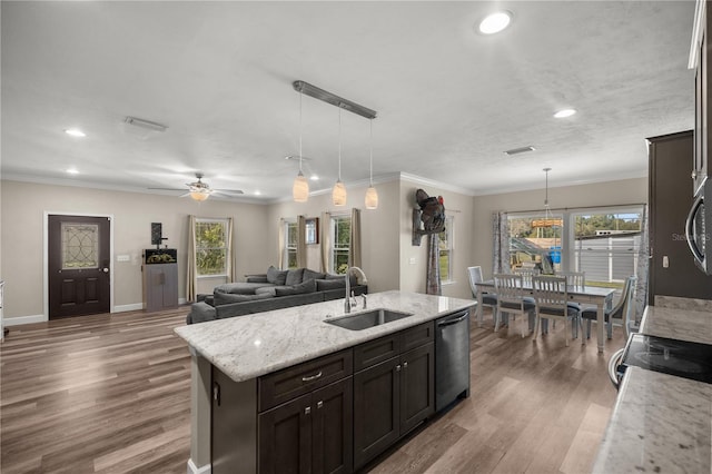 kitchen featuring sink, decorative light fixtures, an island with sink, and appliances with stainless steel finishes