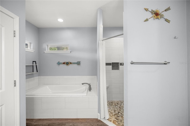 bathroom with wood-type flooring and independent shower and bath