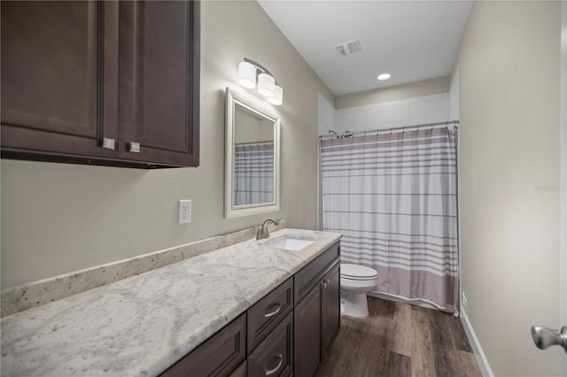 bathroom with hardwood / wood-style flooring, vanity, toilet, and a shower with curtain