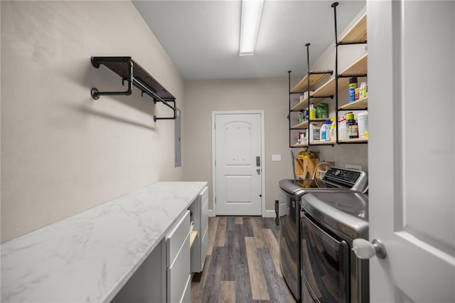 washroom with cabinets, dark hardwood / wood-style flooring, and washer and clothes dryer