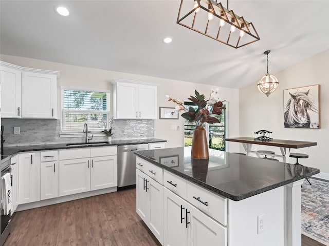 kitchen featuring pendant lighting, sink, a center island, white cabinets, and stainless steel dishwasher