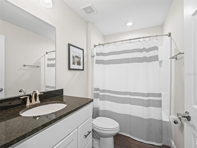 bathroom featuring vanity, toilet, a shower with shower curtain, and hardwood / wood-style floors