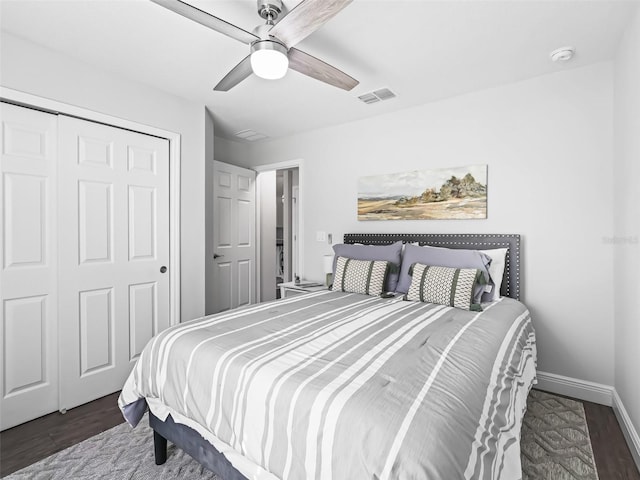 bedroom with dark hardwood / wood-style flooring, a closet, and ceiling fan