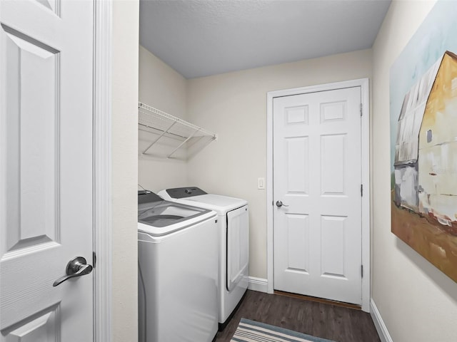 laundry room featuring dark wood-type flooring and separate washer and dryer