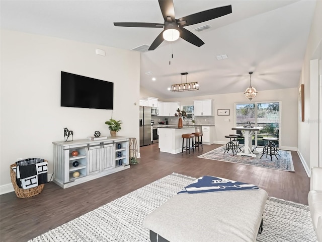 14605 SW 20th Pl, Ocala, FL 34481 - living area featuring visible vents, vaulted ceiling, ceiling fan with notable chandelier, and dark wood finished floors