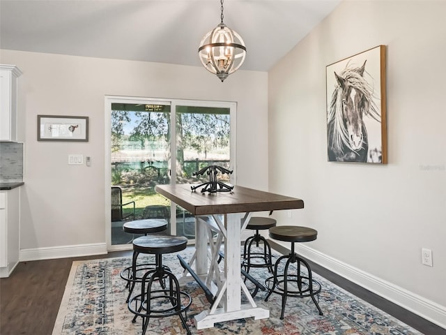 14605 SW 20th Pl, Ocala, FL 34481 - dining space featuring dark wood finished floors, baseboards, a notable chandelier, and vaulted ceiling