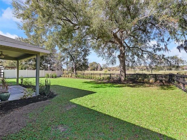 14605 SW 20th Pl, Ocala, FL 34481 - view of yard featuring a ceiling fan, a fenced backyard, and a patio area