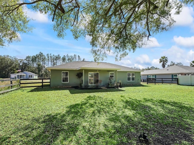 14605 SW 20th Pl, Ocala, FL 34481 - rear view of house with stucco siding, a lawn, and a fenced backyard