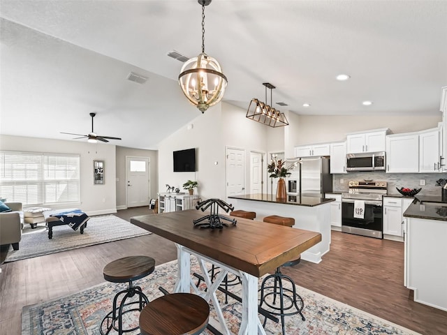 14605 SW 20th Pl, Ocala, FL 34481 - dining area with dark wood-style flooring, recessed lighting, ceiling fan with notable chandelier, and visible vents