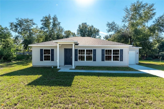 ranch-style house with a front yard, concrete driveway, and roof with shingles