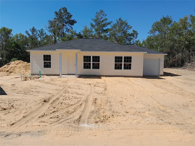 46 Malauka Dr, Ocklawaha, FL 32179 - rear view of property with driveway and a garage