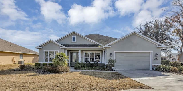 view of front of home featuring a garage, a front lawn, and central air condition unit