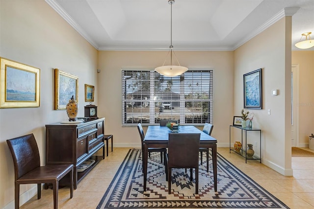 dining room featuring light tile patterned floors and a tray ceiling