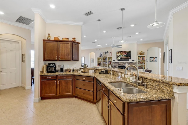 kitchen with crown molding, ceiling fan, sink, and hanging light fixtures