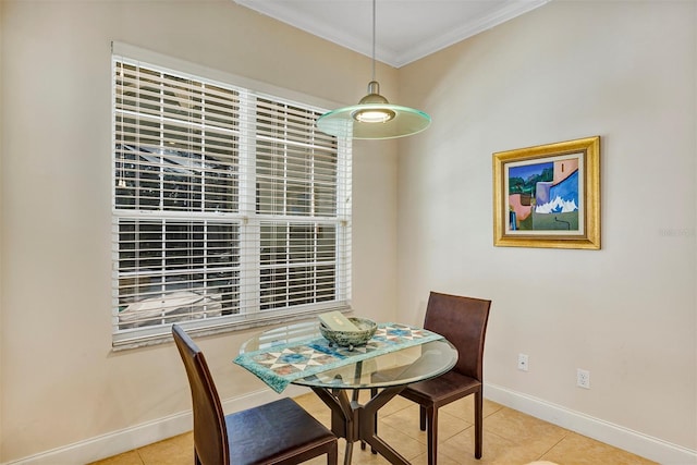 tiled dining room featuring ornamental molding