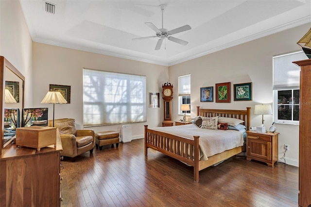 bedroom with dark wood-type flooring, ceiling fan, and ornamental molding