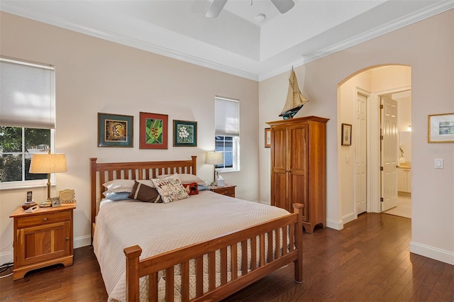 bedroom featuring crown molding, ceiling fan, and dark hardwood / wood-style flooring