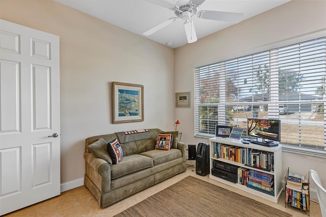 sitting room with ceiling fan and tile patterned flooring