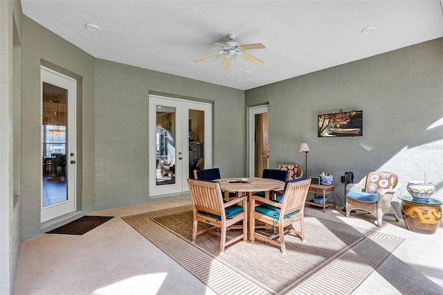 carpeted dining room featuring french doors and ceiling fan