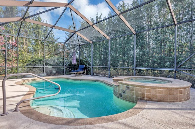 view of pool featuring a lanai, a patio area, and an in ground hot tub